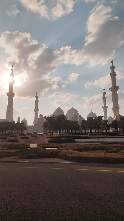 Sheikh Zayed Grand Mosque Courtyard, Grand Mosque Exterior at Sunset, Chandelier in the Main Prayer Hall, World's Largest Hand-Knotted Carpet, Intricate Column Design, Reflective Pools at Night, Visitors in the Mosque's Courtyard, Guided Tour in Progress, Aerial View of the Mosque, Women in Traditional Abayas, #1 tourist attraction in Abu Dhabi